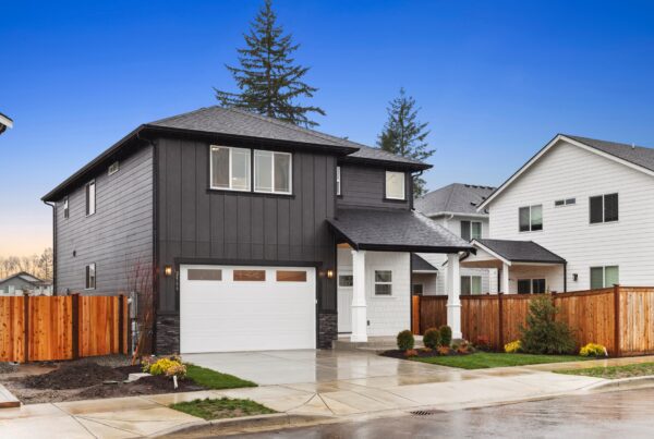 Modern commercial building exterior with dark siding, white accents, and landscaped yard, showcasing Robinett Group's architectural design expertise.